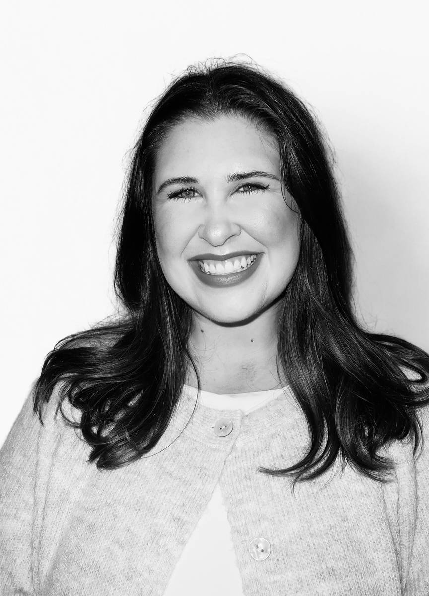 Portrait of Marisa, wedding officiant and ceremony writer, smiling in a cream cardigan